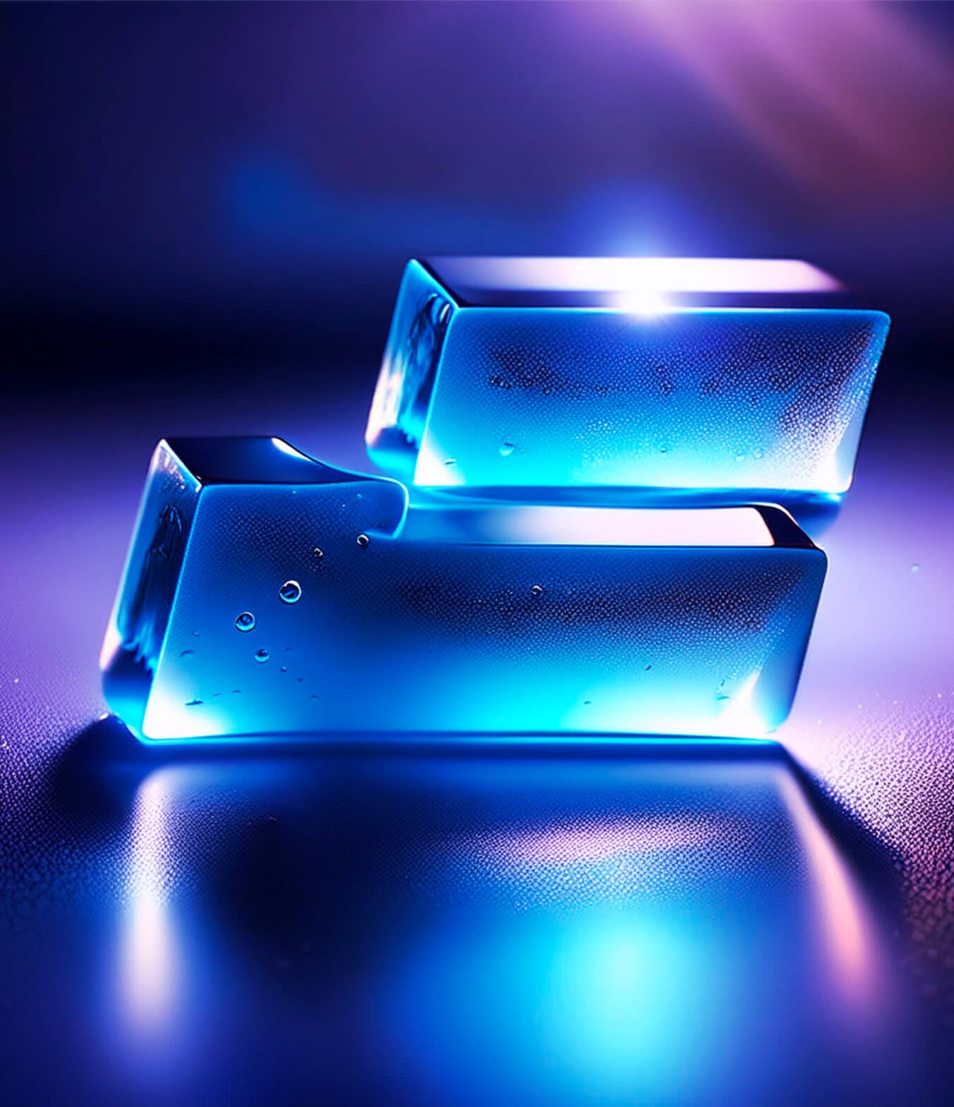 Two rectangular glass blocks Two rectangular glass blocks stacked unevenly, illuminated with a cool blue glow against a blurred, dark background. Reflections and bubbles inside the glass add to the ethereal, futuristic aesthetic.